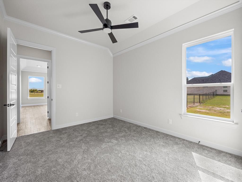161 Frontera Drive Decatur, TX 76234 - Photo 18 of 40 an empty room with a window and a ceiling fan