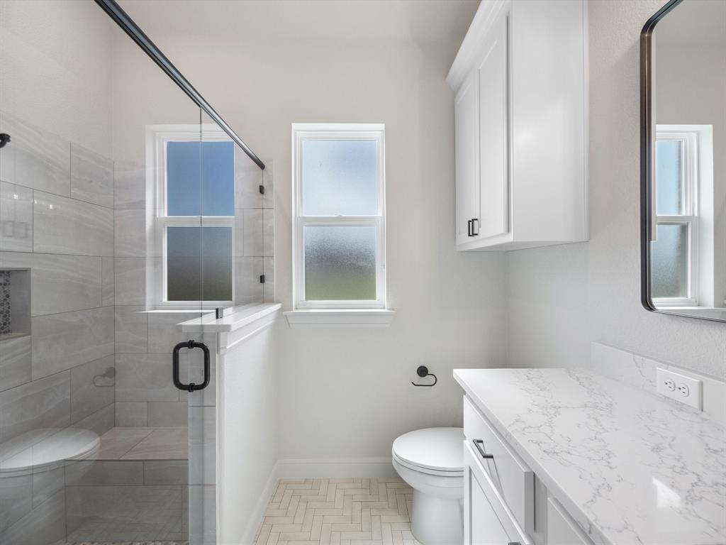 161 Frontera Drive Decatur, TX 76234 - Photo 20 of 40 a bathroom with a granite countertop toilet sink and mirror