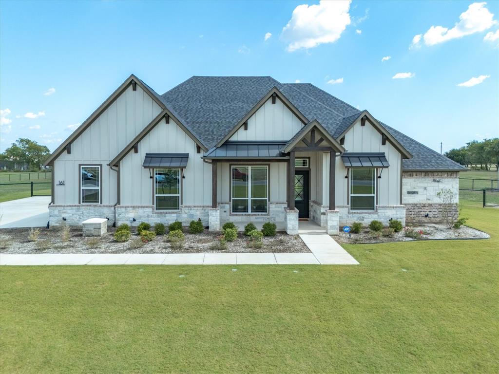 161 Frontera Drive Decatur, TX 76234 - Photo 2 of 40 a front view of a house with swimming pool and porch with furniture