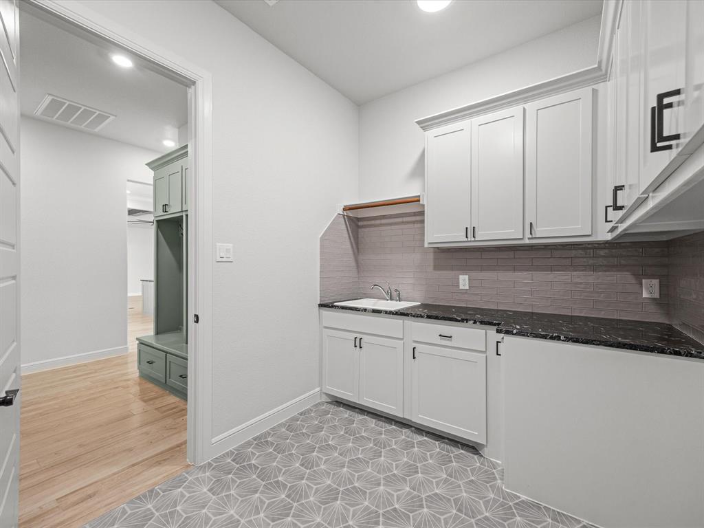 161 Frontera Drive Decatur, TX 76234 - Photo 28 of 40 a kitchen with granite countertop a sink and cabinets