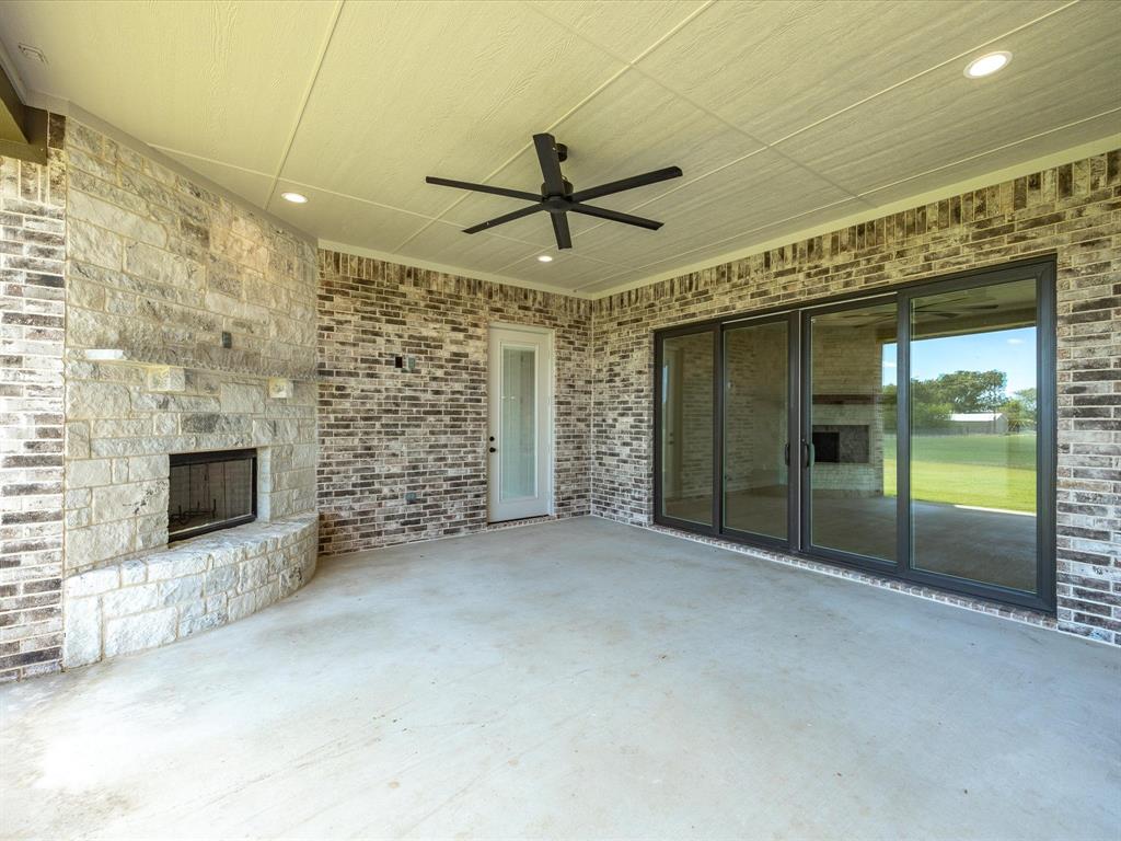 161 Frontera Drive Decatur, TX 76234 - Photo 38 of 40 a view of a livingroom with a fireplace a ceiling fan and window