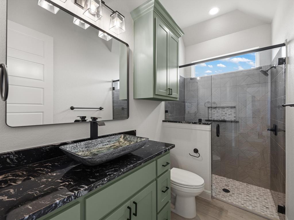 161 Frontera Drive Decatur, TX 76234 - Photo 9 of 40 a bathroom with a granite countertop sink toilet and shower