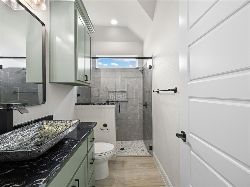 161 Frontera Drive Decatur, TX 76234 - Photo 10 of 40 a bathroom with a granite countertop toilet a sink and shower