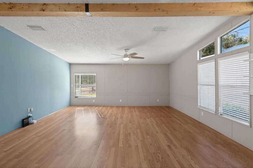 2744 Roy Sikes Road Hilliard, FL 32046 - Photo 37 of 97 a view of an empty room with wooden floor and a window