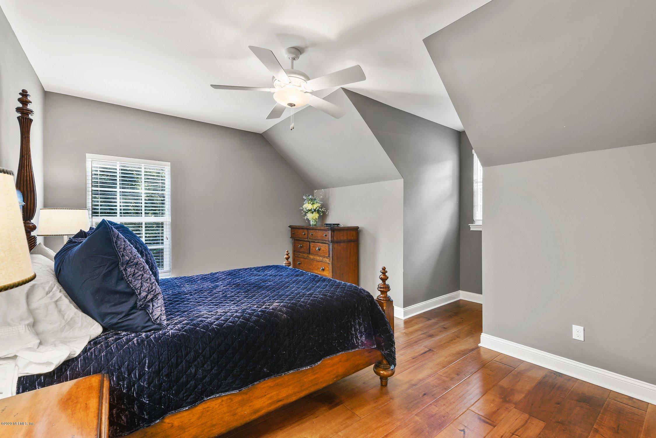1217 Wedgewood Road Fruit Cove, FL 32259 - Photo 46 of 69 a bedroom with a large bed and a chandelier