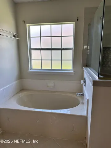 a bathroom with a bathtub and a sink