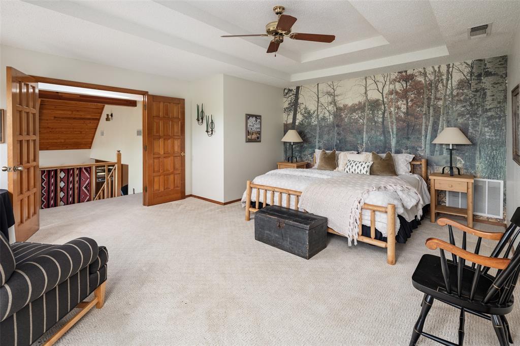 1251 Jim Cannon Road Van Alstyne, TX 75495 - Photo 17 of 31 a bedroom with a bed and a chandelier