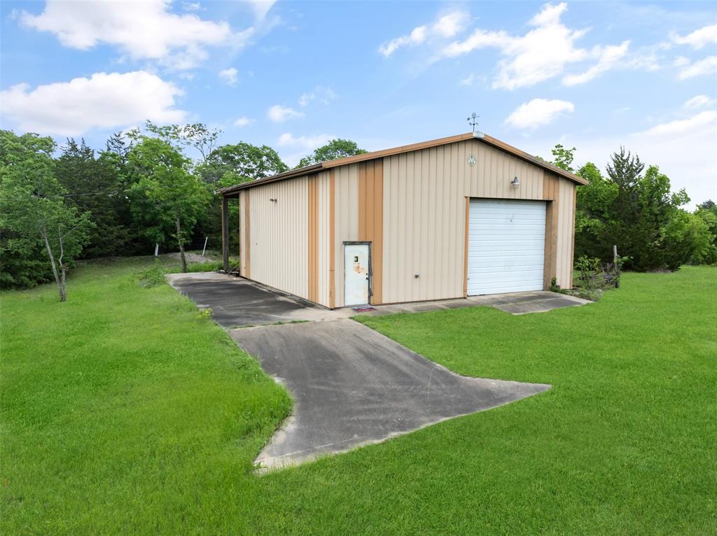 1251 Jim Cannon Road Van Alstyne, TX 75495 - Photo 25 of 31 a view of a backyard with potted plants and a large tree