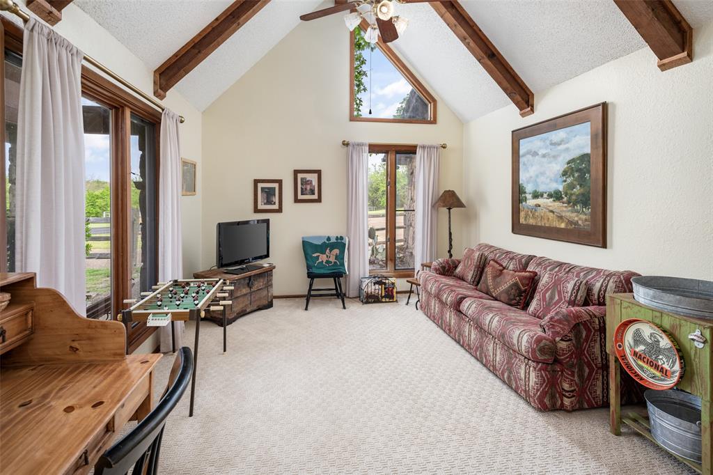 1251 Jim Cannon Road Van Alstyne, TX 75495 - Photo 9 of 31 a living room with furniture a flat screen tv and a large window