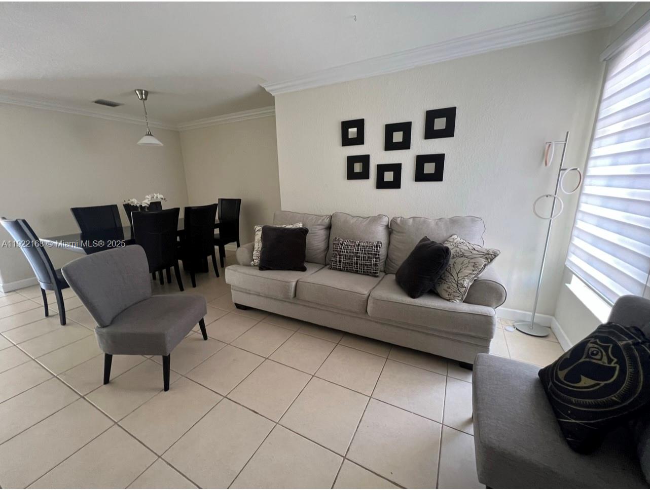 7317 Northwest 173rd Drive, Unit 104 Hialeah, FL 33015 - Photo 13 of 22 a living room with furniture and a large window