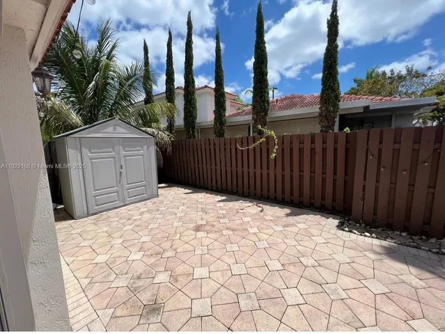 a outside view of a house with a wooden fence