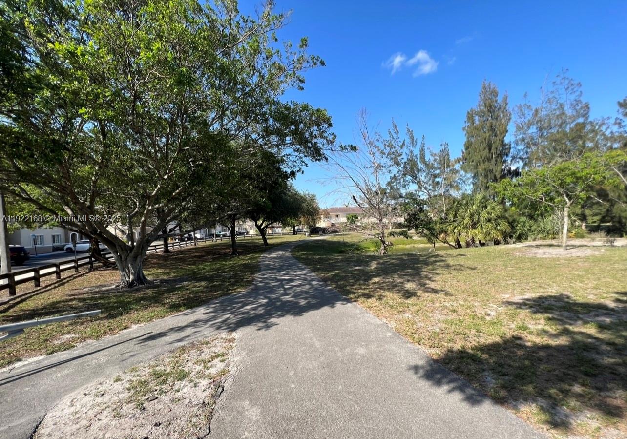 7317 Northwest 173rd Drive, Unit 104 Hialeah, FL 33015 - Photo 21 of 22 a view of road with trees