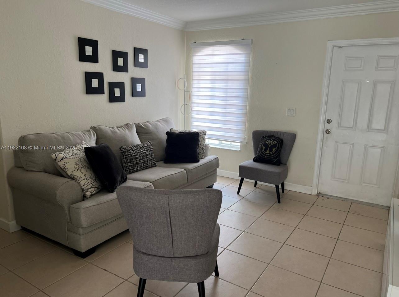 7317 Northwest 173rd Drive, Unit 104 Hialeah, FL 33015 - Photo 4 of 22 a living room with furniture and a window