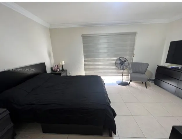 a bedroom with a bed and a chair