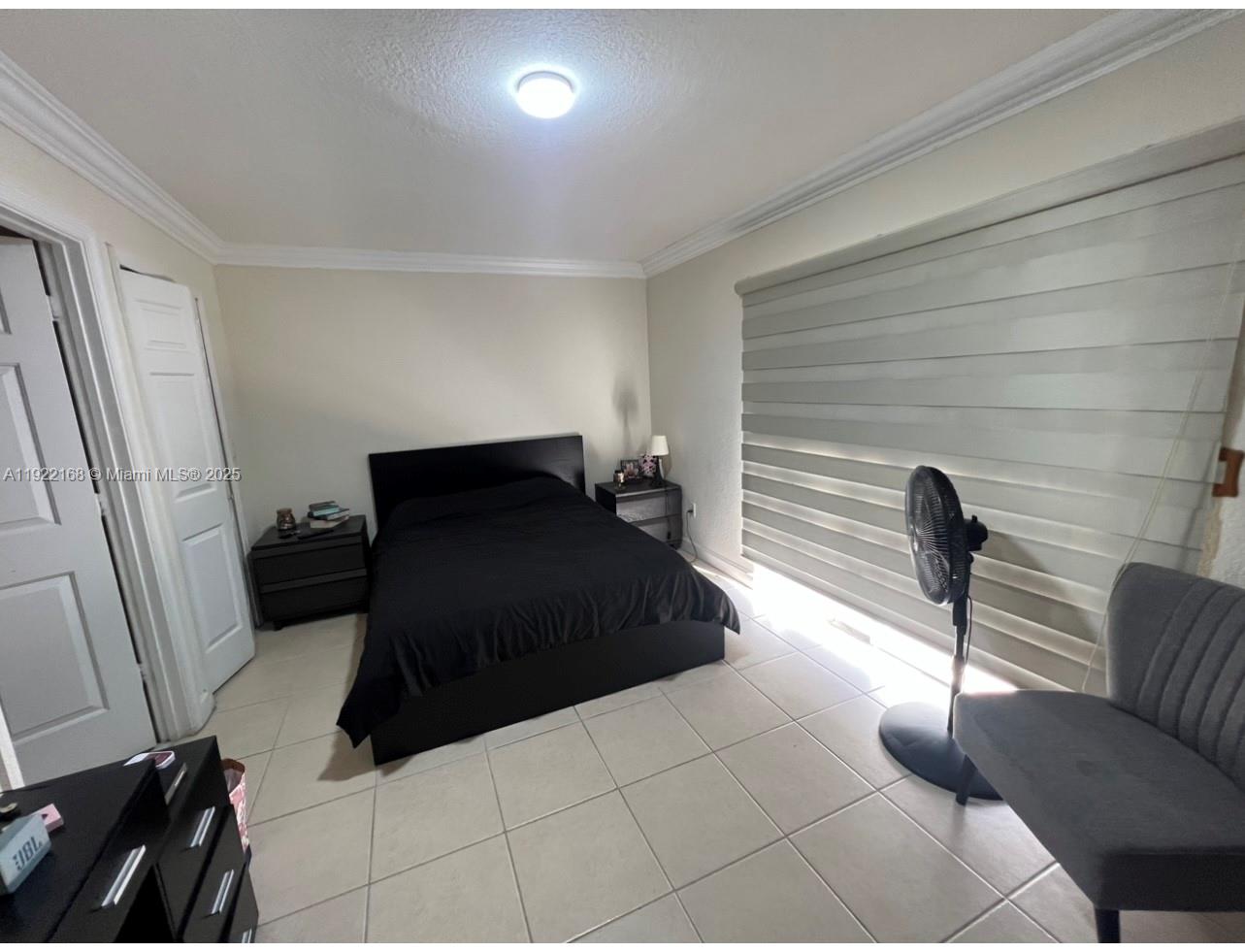 7317 Northwest 173rd Drive, Unit 104 Hialeah, FL 33015 - Photo 9 of 22 a bedroom with a bed and a couch