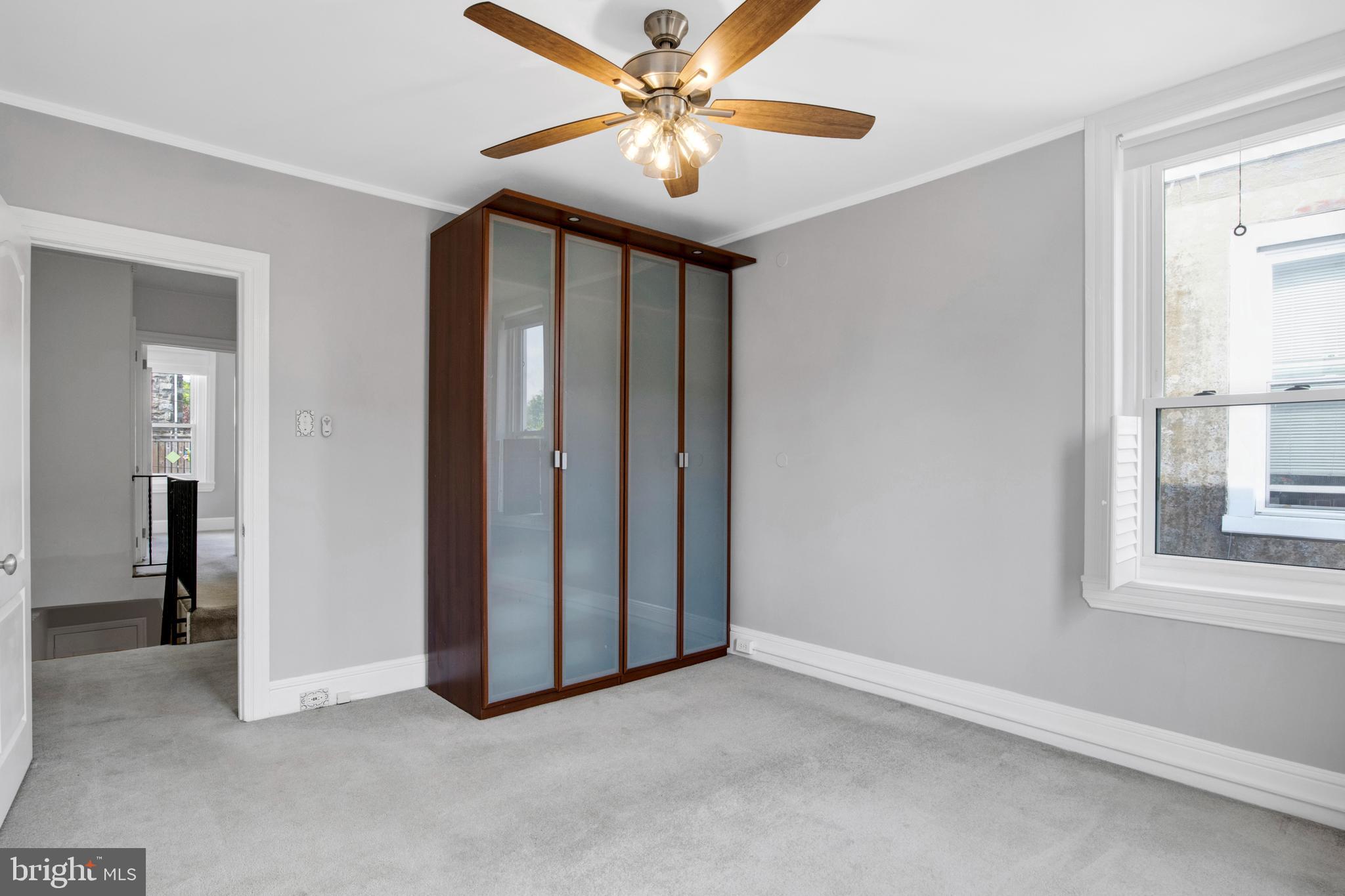 7205 Howard Terrace Philadelphia, PA 19119 - Photo 15 of 23 an empty room with chandelier fan and windows