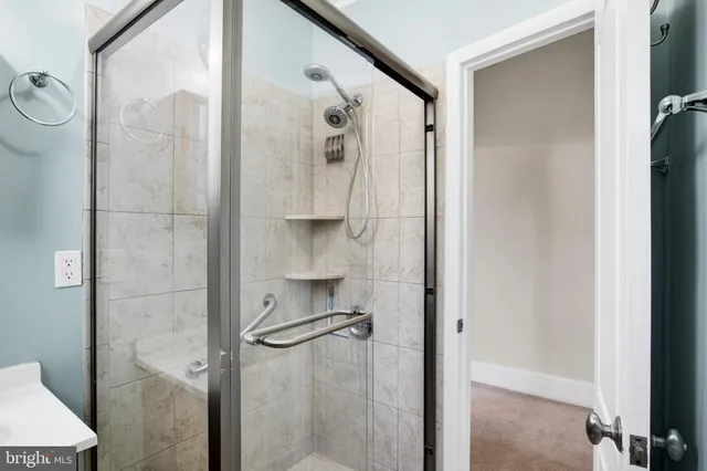 a bathroom with a toilet and a glass door shower