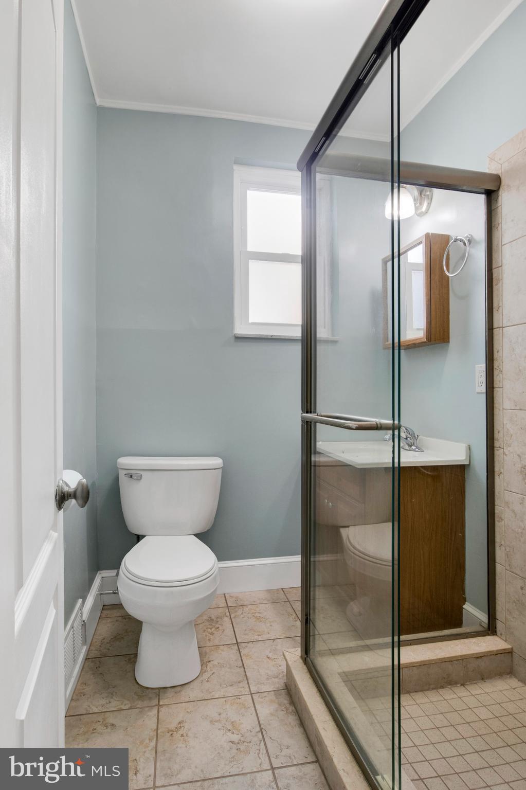 7205 Howard Terrace Philadelphia, PA 19119 - Photo 21 of 23 a bathroom with a toilet and a glass door shower