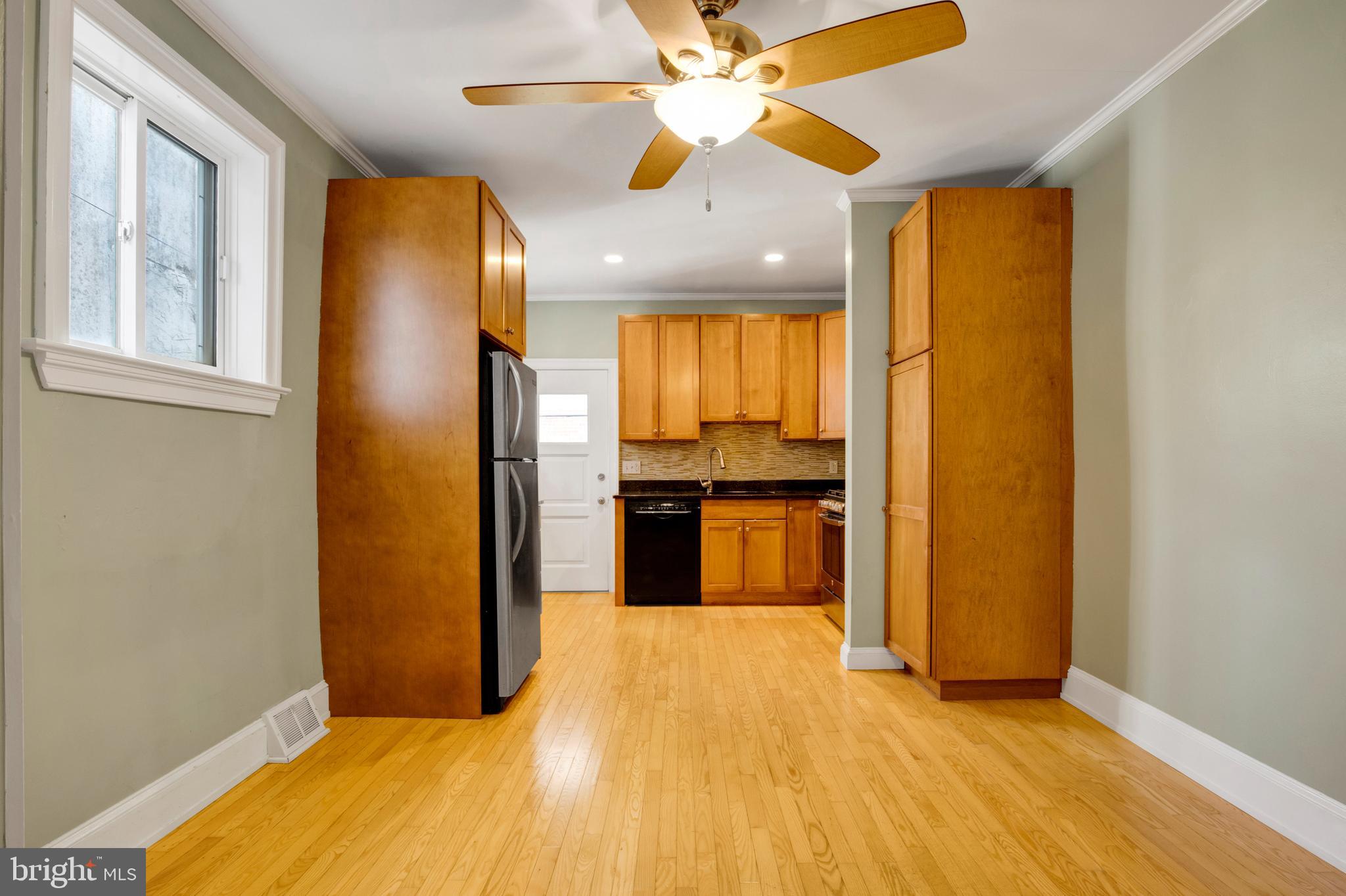 7205 Howard Terrace Philadelphia, PA 19119 - Photo 9 of 23 a kitchen with stainless steel appliances granite countertop a refrigerator a oven a sink with wooden floors and cabinets