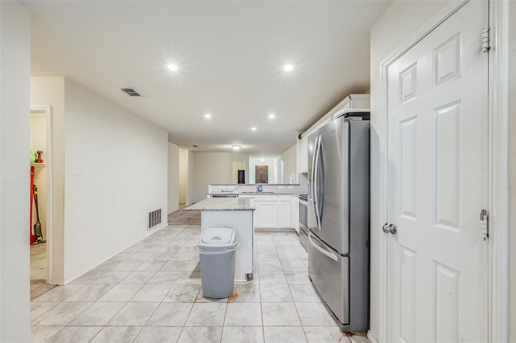 1062 Spofford Drive Forney, TX 75126 - Photo 12 of 23 a kitchen with a refrigerator and a sink