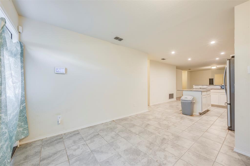 1062 Spofford Drive Forney, TX 75126 - Photo 14 of 23 a kitchen with a refrigerator and a sink