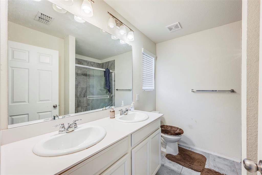1062 Spofford Drive Forney, TX 75126 - Photo 16 of 23 a bathroom with a sink and a mirror