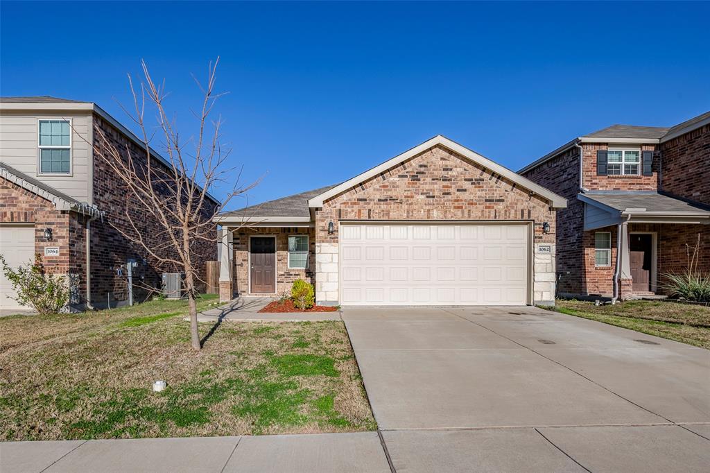 1062 Spofford Drive Forney, TX 75126 - Photo 2 of 23 a front view of a house with a yard and garage