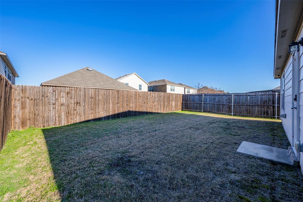 1062 Spofford Drive Forney, TX 75126 - Photo 22 of 23 a view of a backyard with a garden