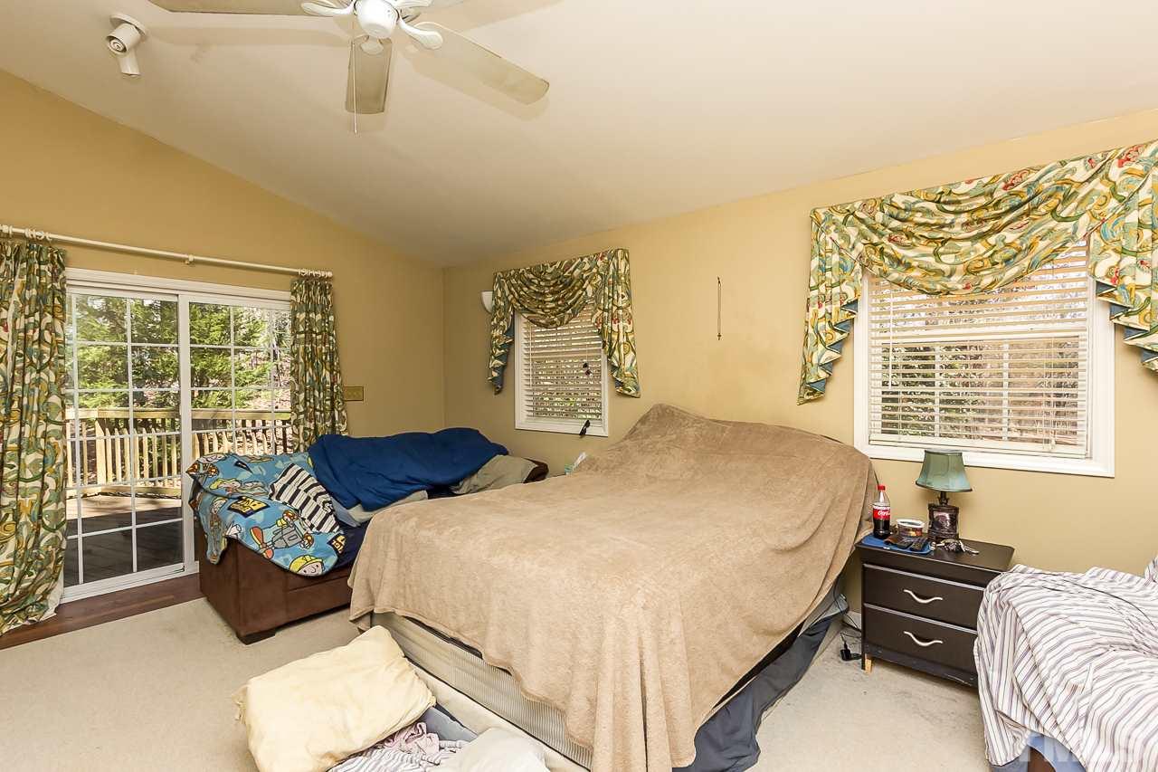 3518 Moriah Road Rougemont, NC 27572 - Photo 13 of 25 a bedroom with a bed couch and large window