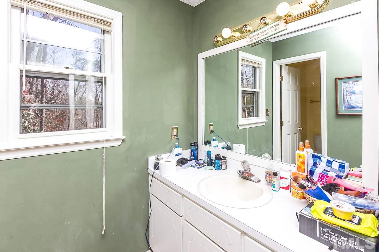 3518 Moriah Road Rougemont, NC 27572 - Photo 17 of 25 a bathroom with a sink vanity and a mirror