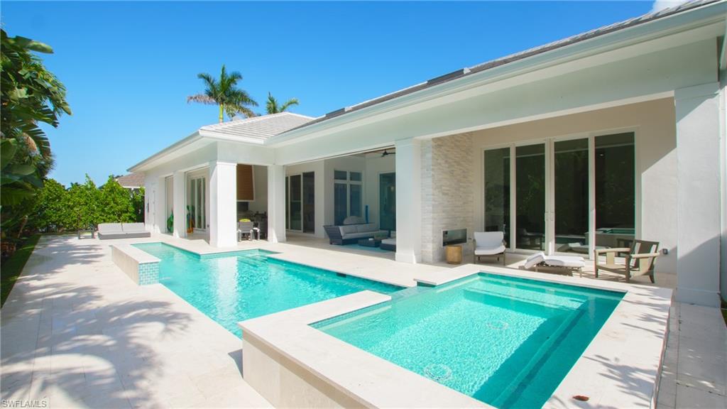 700 Wedge Drive Naples, FL 34103 - Photo 2 of 19 View of swimming pool with an in ground hot tub and a patio area