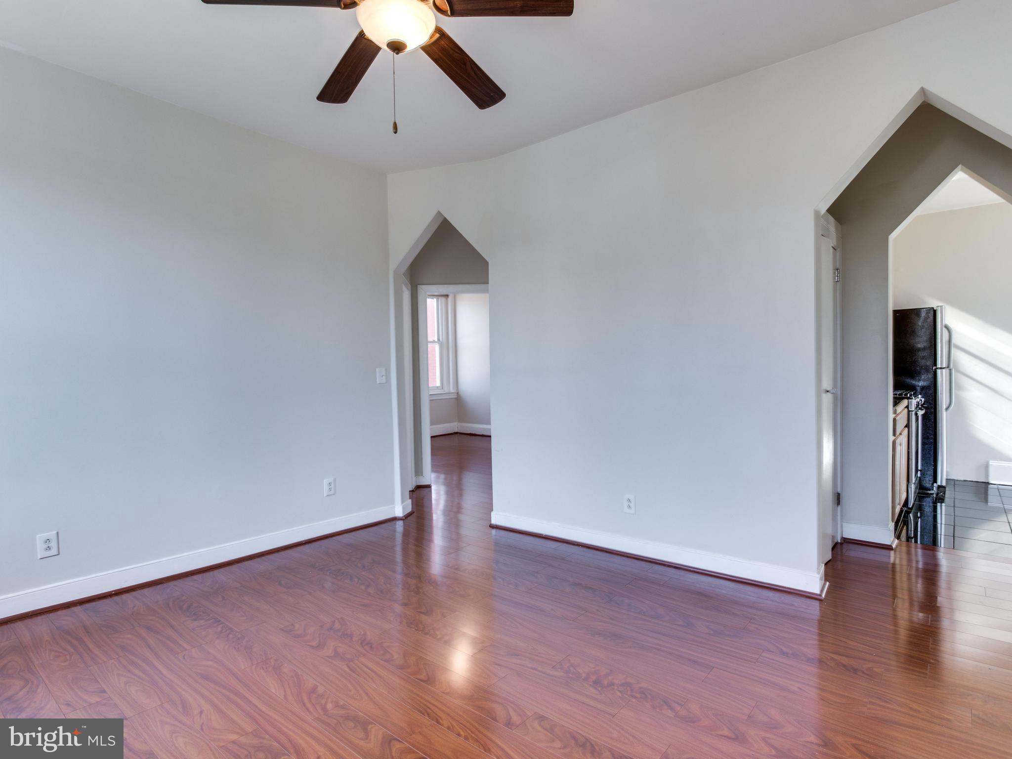 1954 Calvert Street Northwest Washington, DC 20009 - Photo 18 of 28 a view of empty room with wooden floor and fan