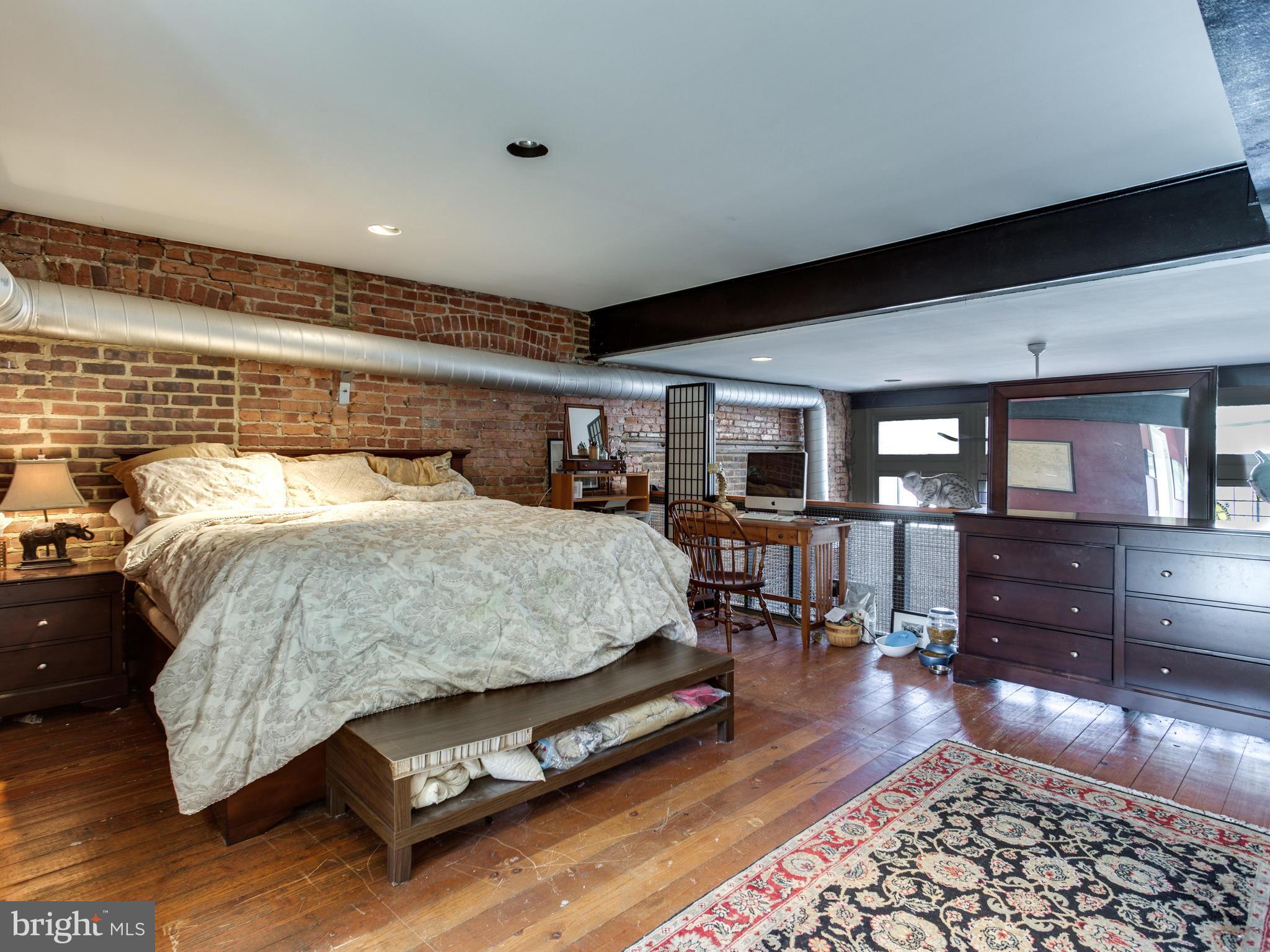 1954 Calvert Street Northwest Washington, DC 20009 - Photo 4 of 28 a bedroom with furniture and wooden floor