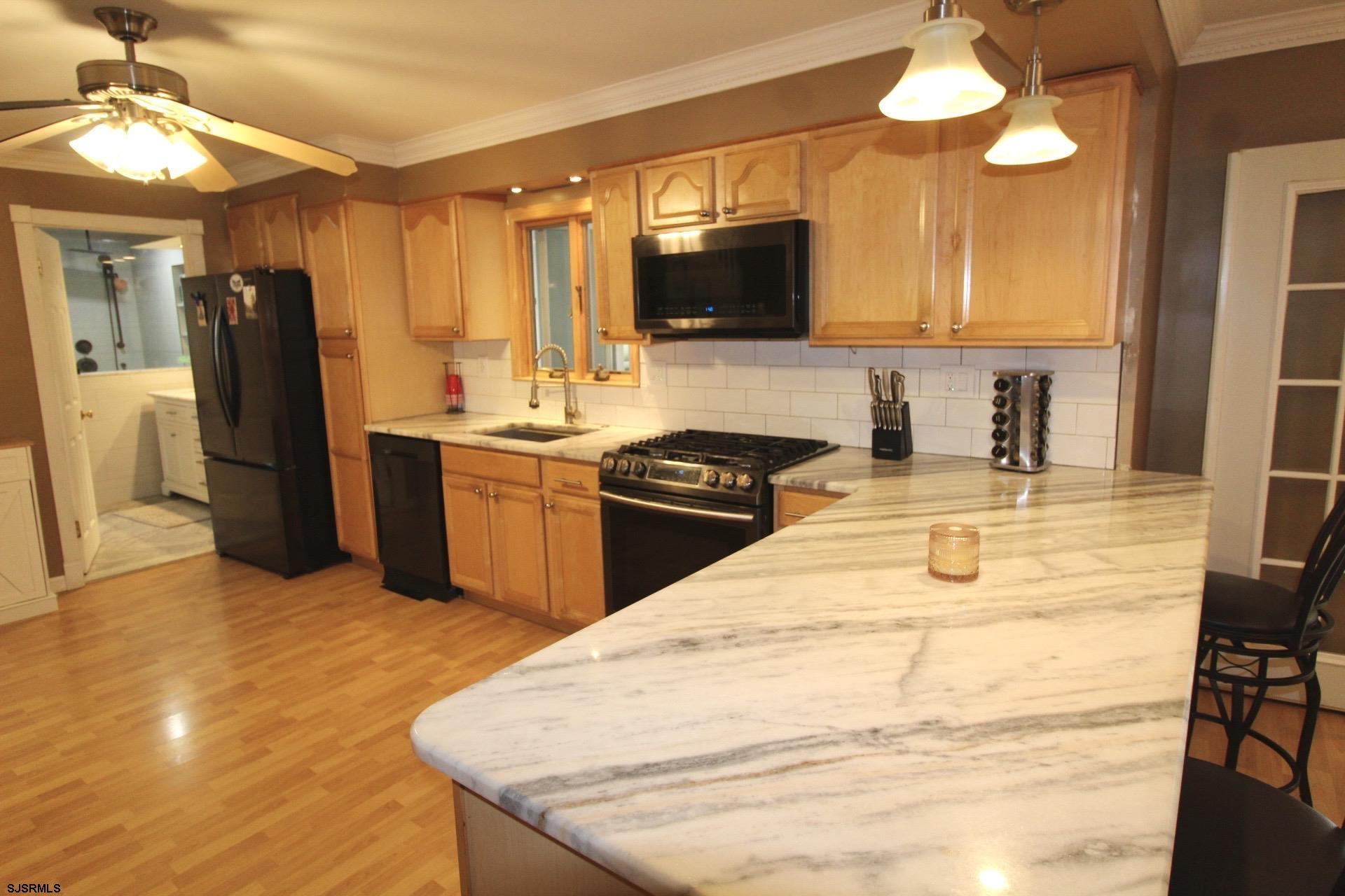 107 Spray Avenue Egg Harbor Township, NJ 08234 - Photo 11 of 38 a kitchen with stainless steel appliances granite countertop a sink a stove and a refrigerator