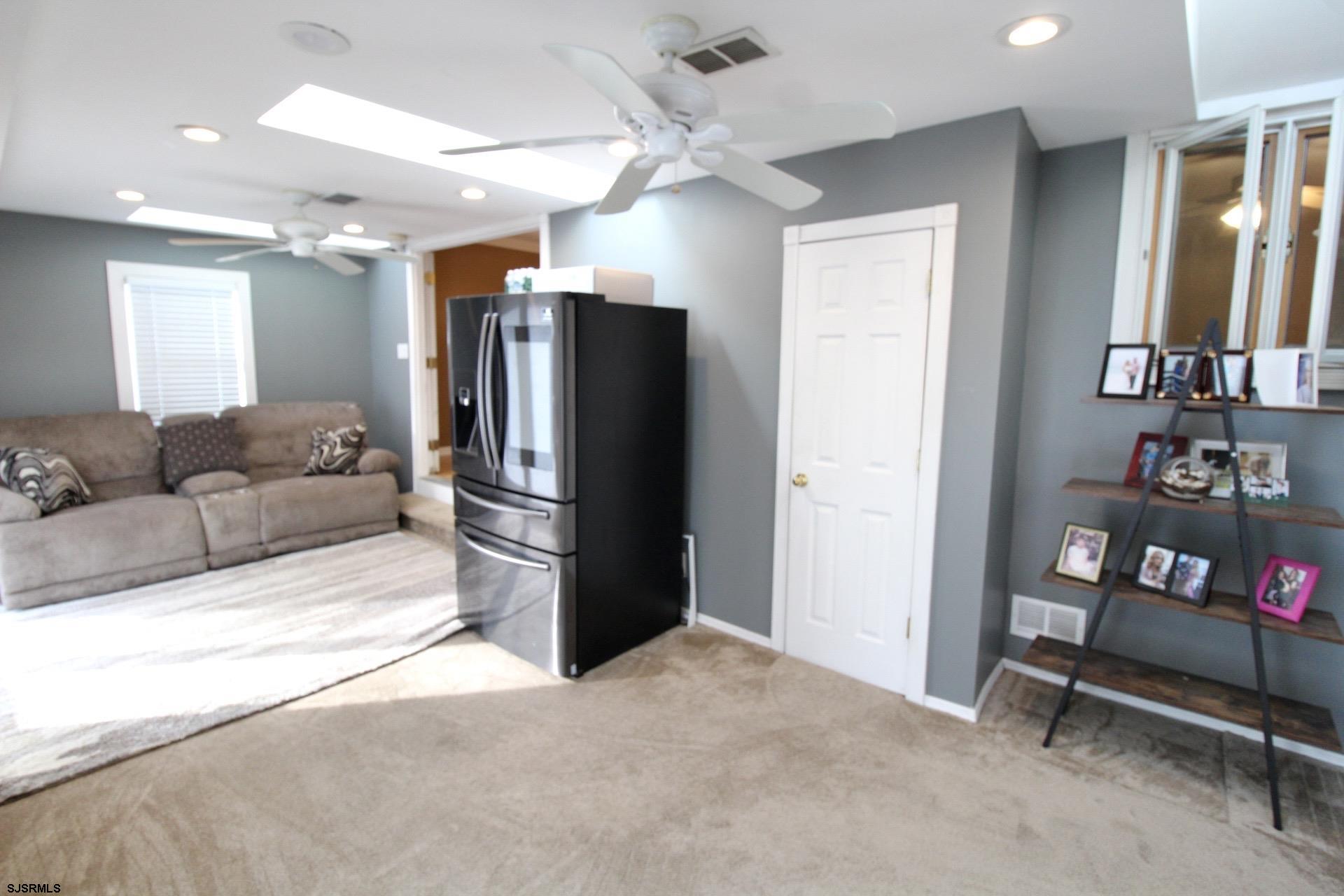 107 Spray Avenue Egg Harbor Township, NJ 08234 - Photo 14 of 38 a living room with furniture a ceiling fan and a rug