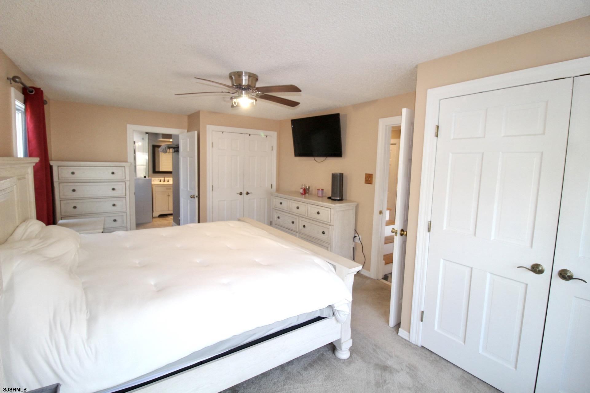 107 Spray Avenue Egg Harbor Township, NJ 08234 - Photo 18 of 38 a bedroom with a bed and a flat screen tv