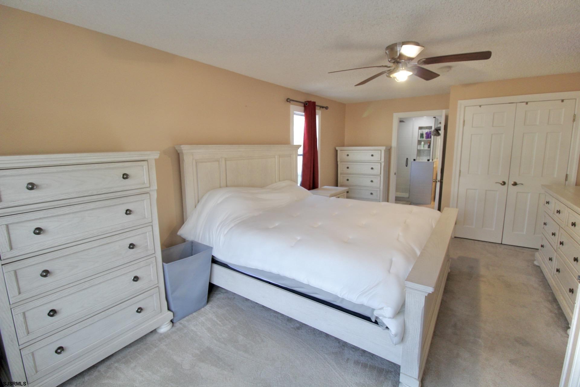107 Spray Avenue Egg Harbor Township, NJ 08234 - Photo 19 of 38 a spacious bedroom with a bed and a dresser