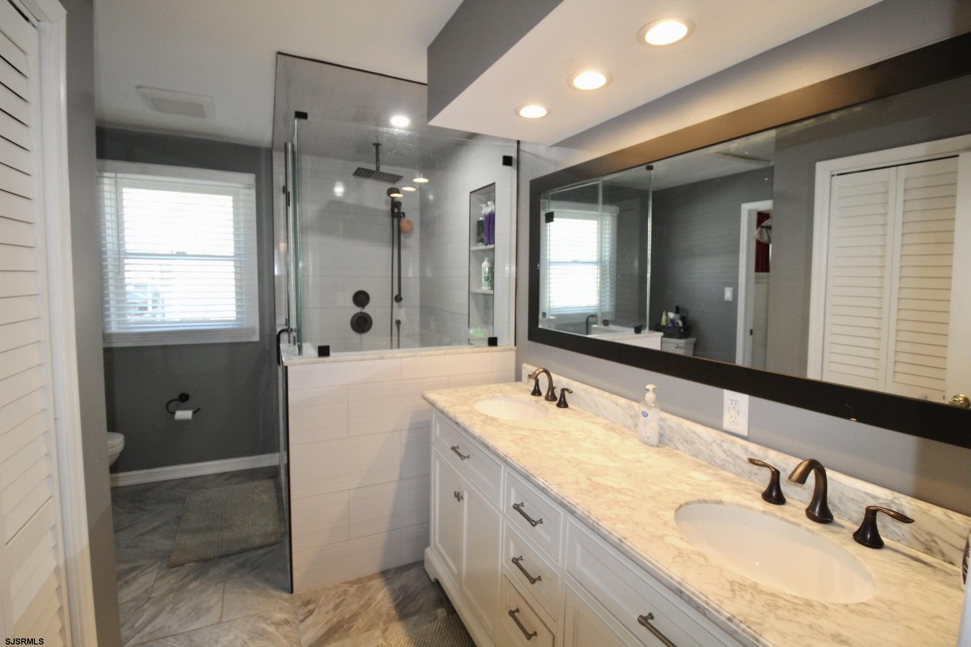 107 Spray Avenue Egg Harbor Township, NJ 08234 - Photo 20 of 38 a bathroom with a granite countertop sink mirror and double