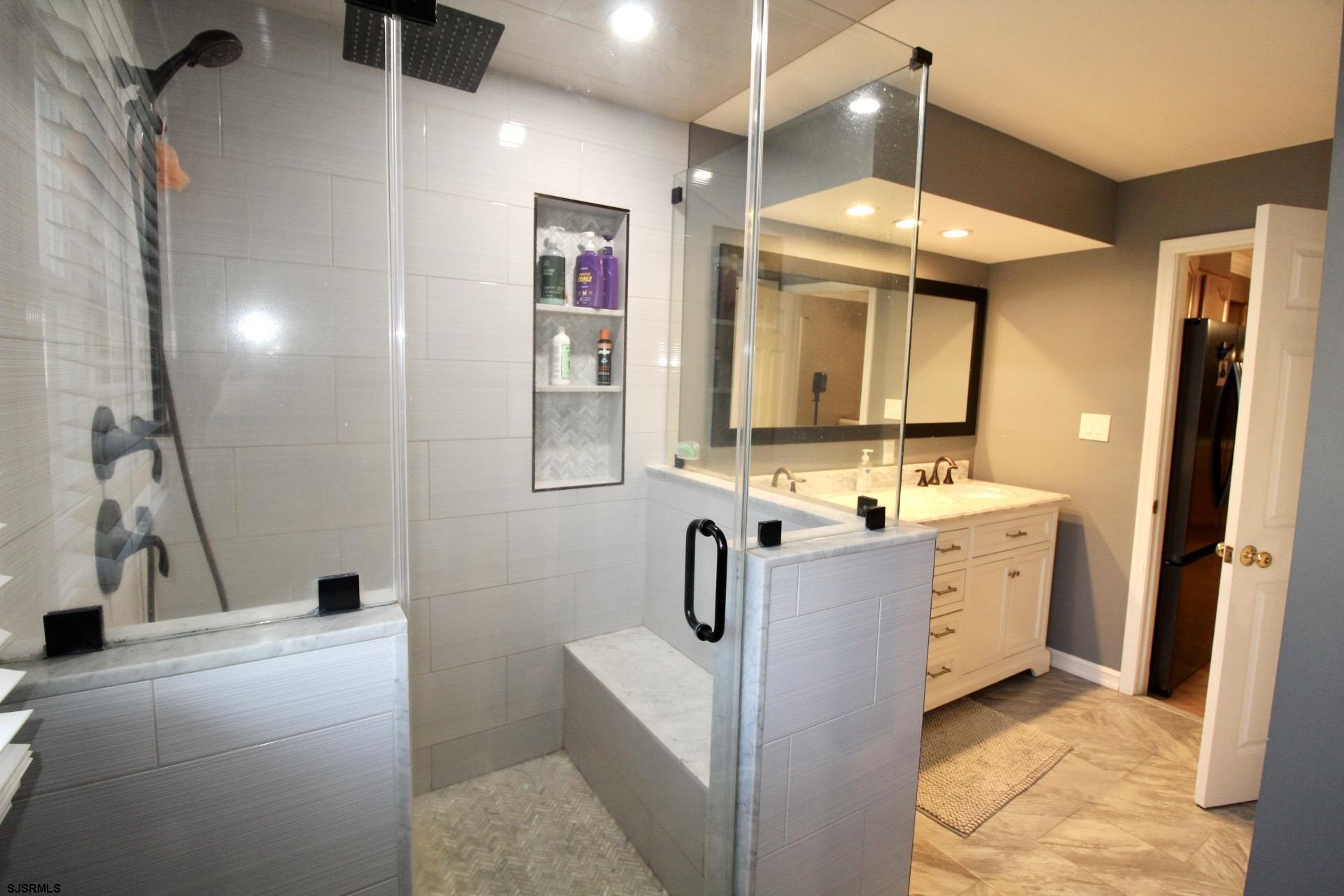 107 Spray Avenue Egg Harbor Township, NJ 08234 - Photo 21 of 38 a bathroom with double vanity sink a mirror and shower