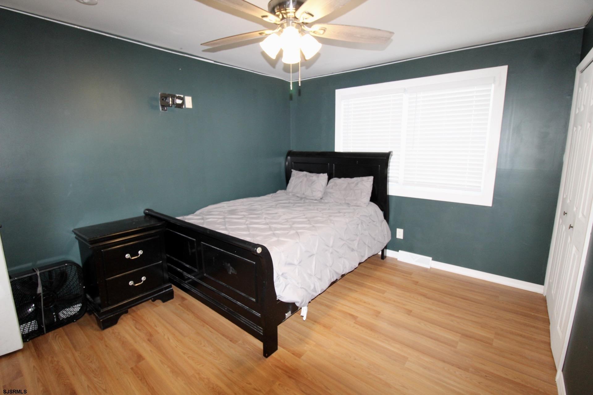 107 Spray Avenue Egg Harbor Township, NJ 08234 - Photo 24 of 38 a bedroom with a bed and a chandelier