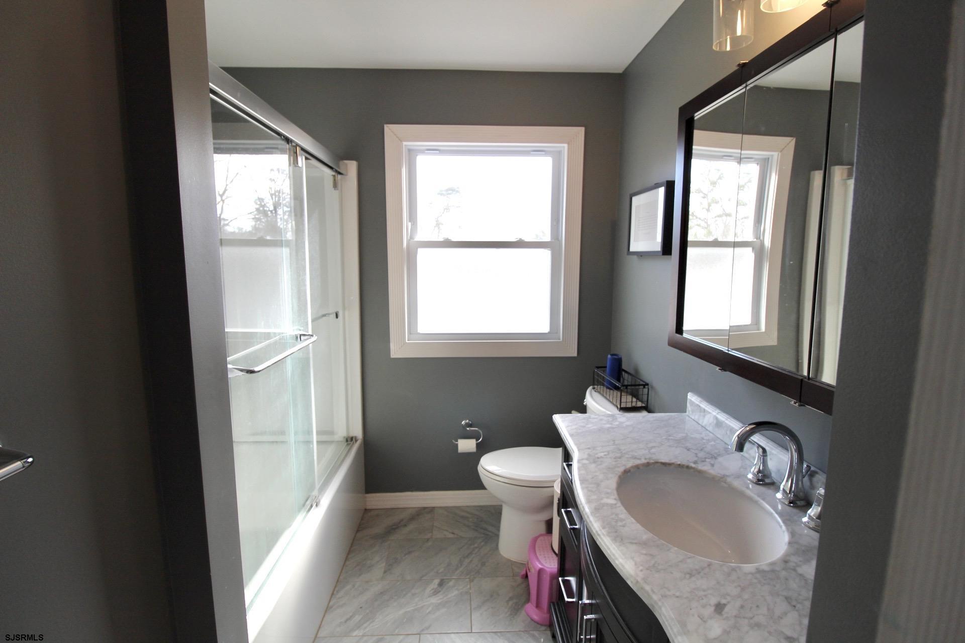 107 Spray Avenue Egg Harbor Township, NJ 08234 - Photo 25 of 38 a bathroom with a granite countertop sink and a mirror