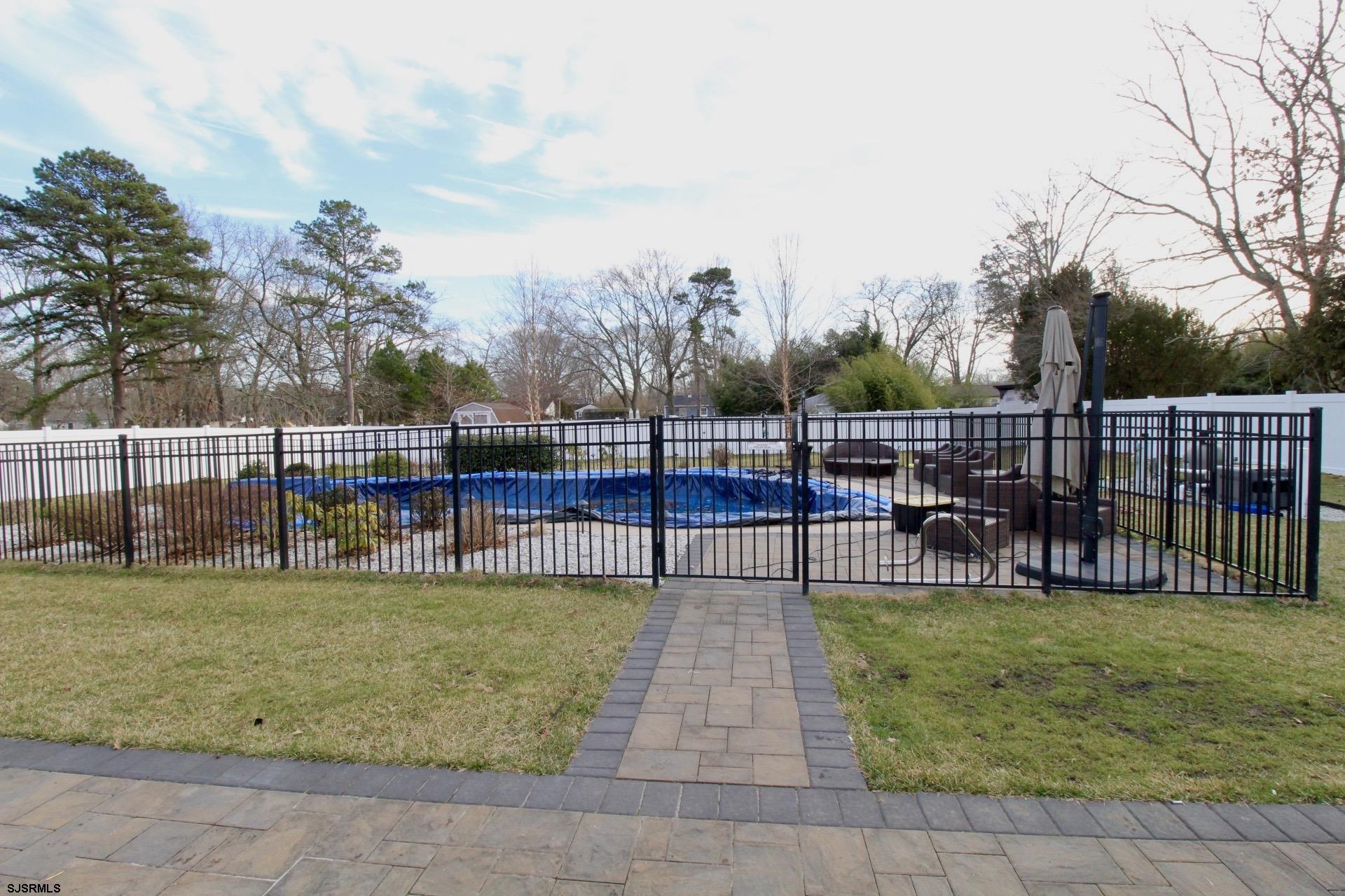 107 Spray Avenue Egg Harbor Township, NJ 08234 - Photo 34 of 38 a view of a swimming pool with a garden