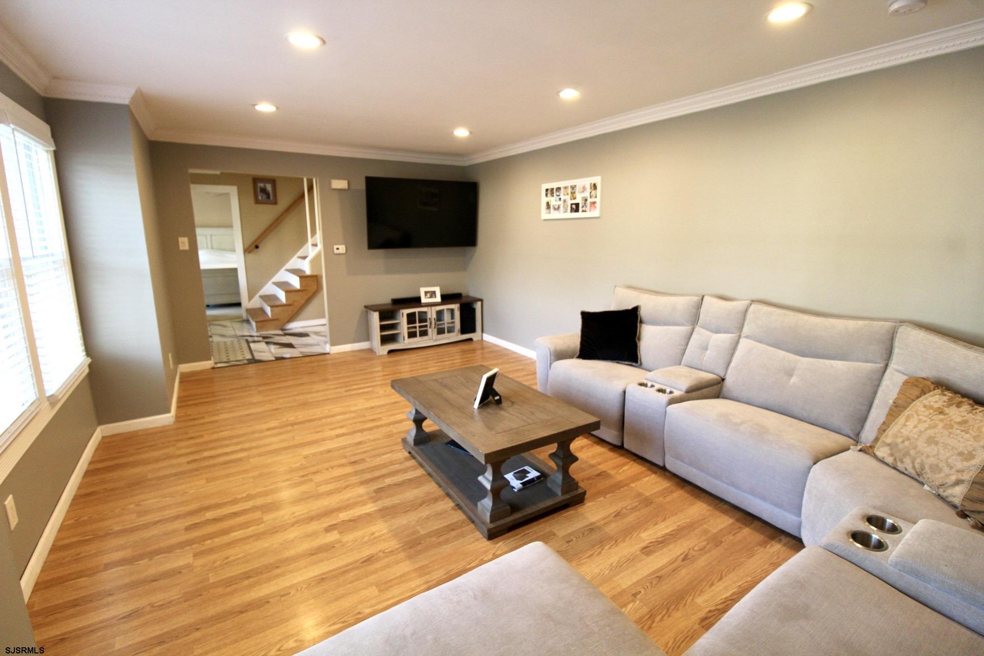 107 Spray Avenue Egg Harbor Township, NJ 08234 - Photo 7 of 38 a living room with furniture and a flat screen tv