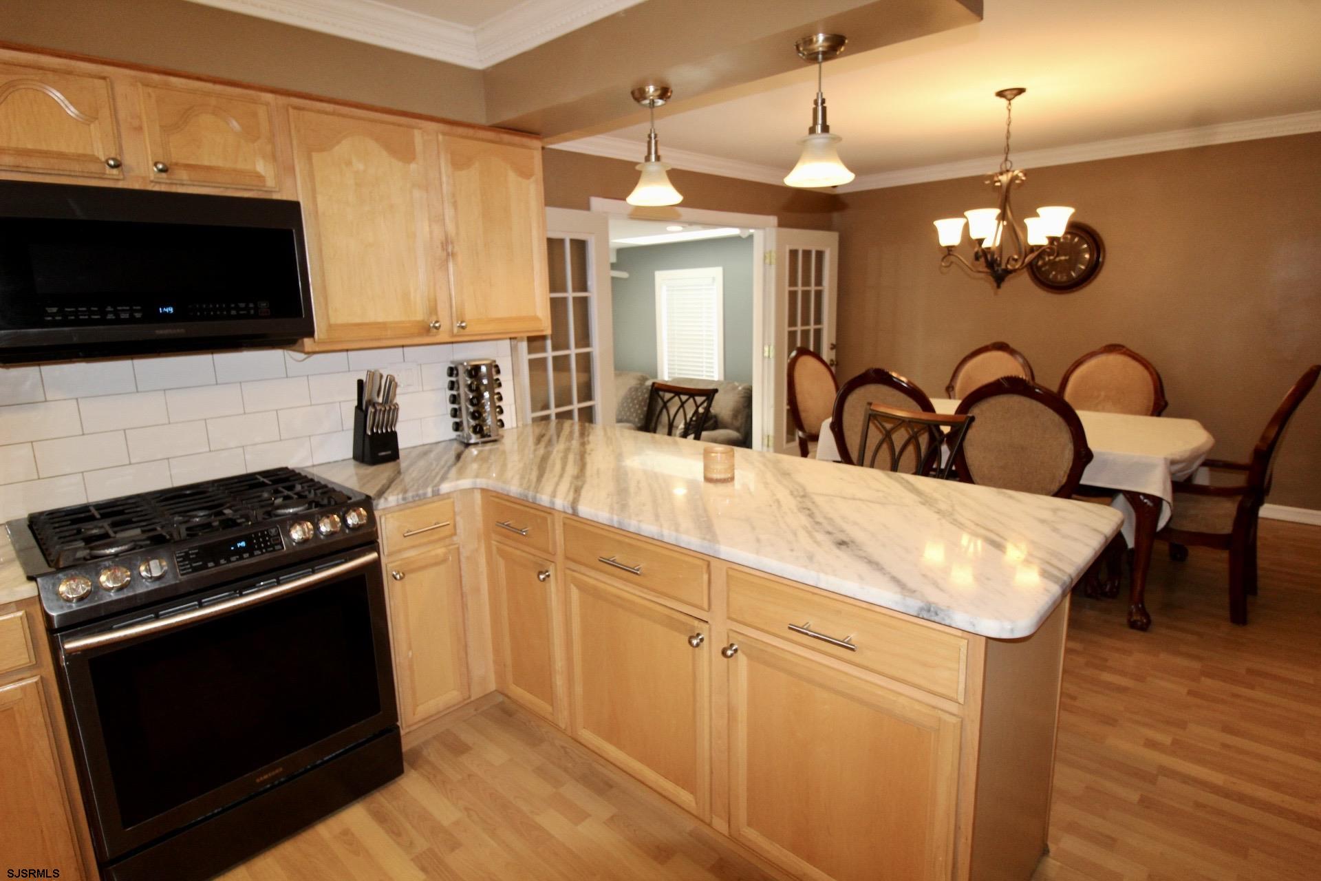 107 Spray Avenue Egg Harbor Township, NJ 08234 - Photo 10 of 38 a kitchen with stainless steel appliances granite countertop a stove a sink and a microwave