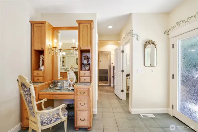 a kitchen with stainless steel appliances granite countertop a stove top oven a sink a dining table and chairs with wooden floor