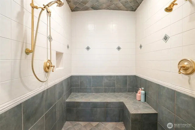 a living room with furniture a flat screen tv and a wall painting