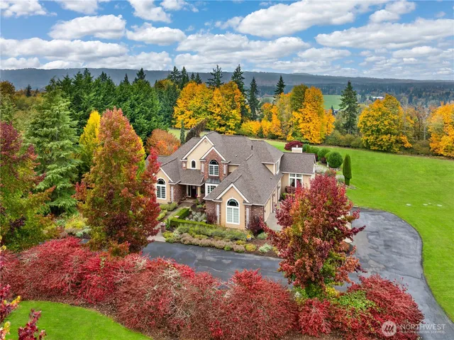an aerial view of a house with a yard basket ball court and outdoor seating