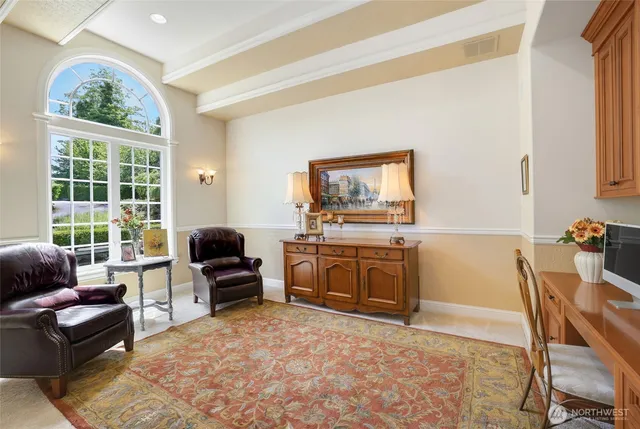 a view of a dining room with furniture a chandelier and wooden floor