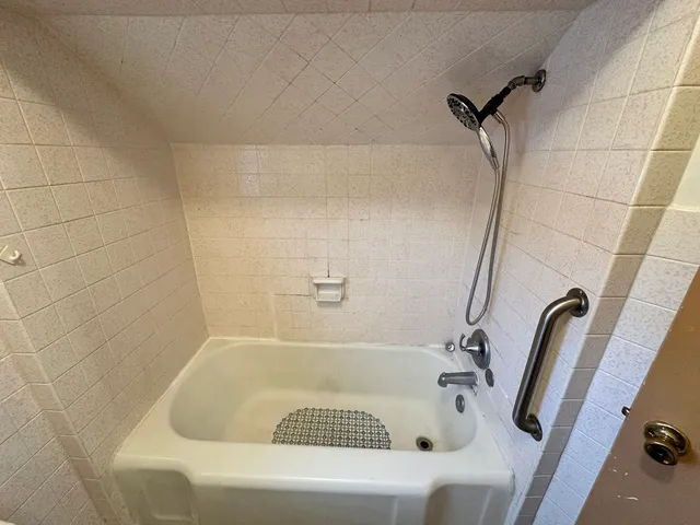 a bathroom with a bathtub and shower