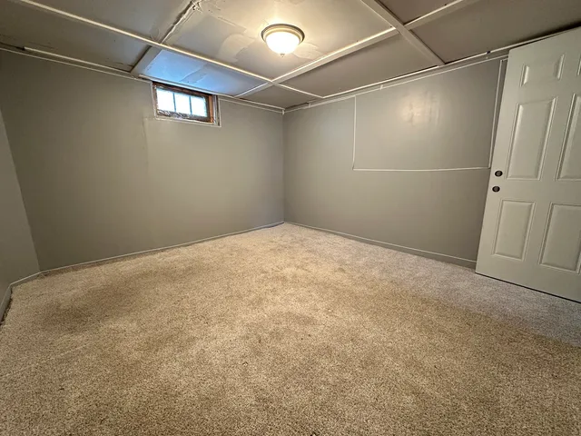 a view of a room with wooden floor and stainless steel appliances